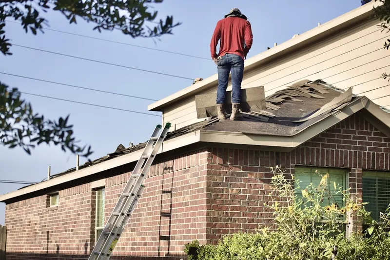 Professional roofer working on a residential roof in Sunset Village